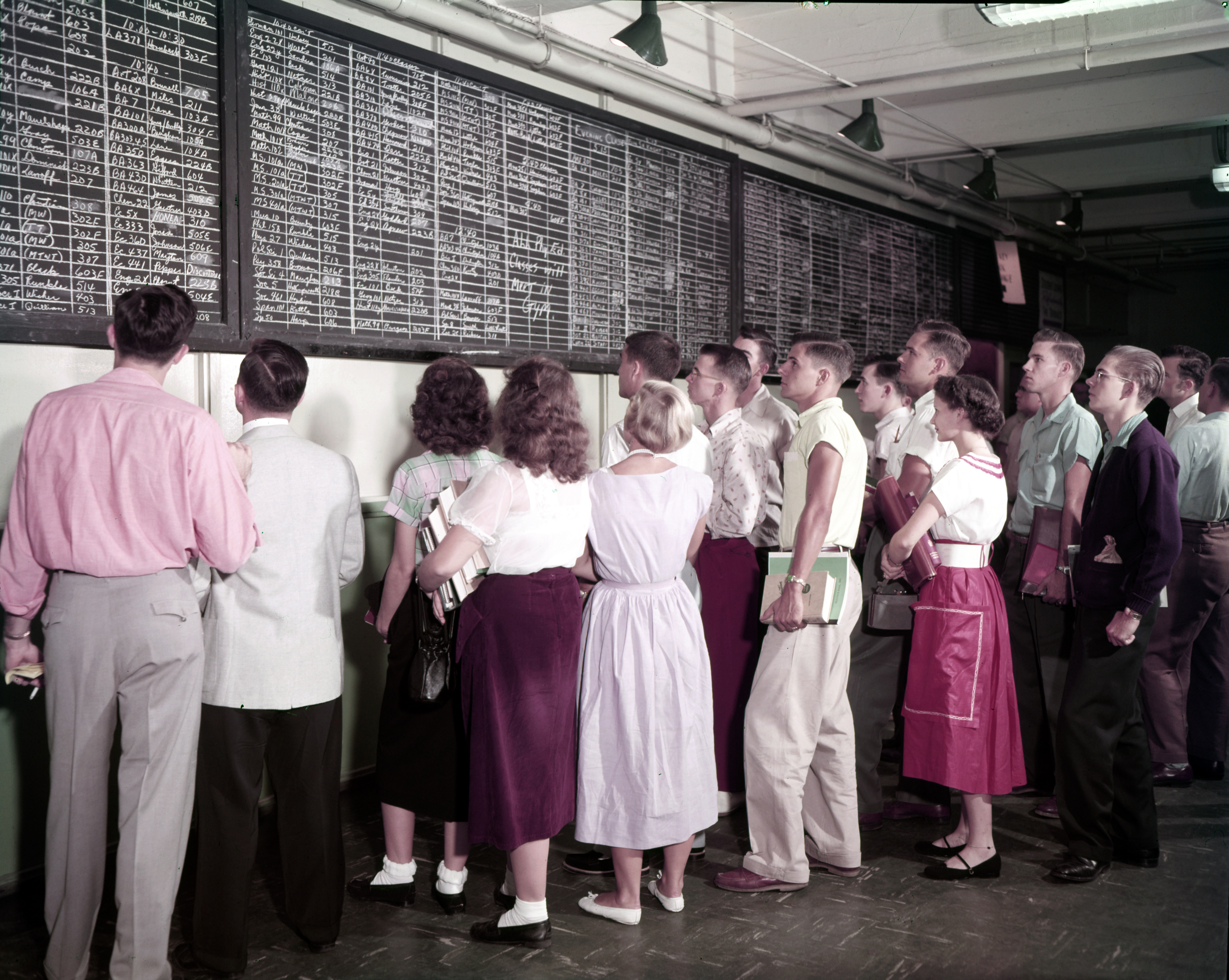 Photograph of students gathered to view the course board in Kell Hall, 1953