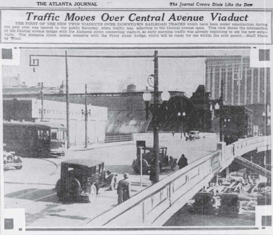 Newspaper clipping with photo of cars, pedestrians, and streetcar on the viaduct
