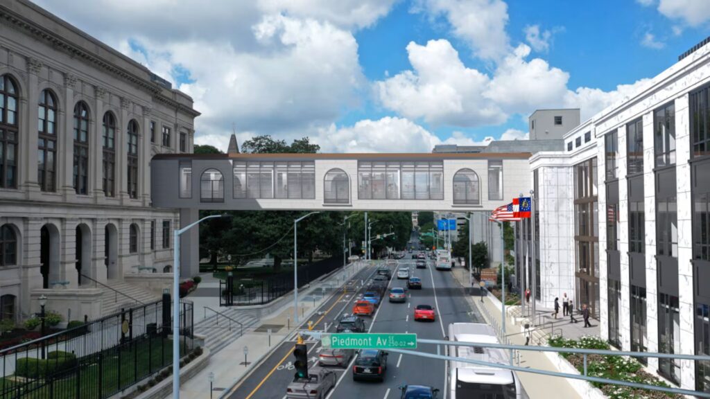 Architects' rendering of pedestrian skybridge being built facing west from Piedmont Ave. and down MLK Jr. Drive with cars and a bus passing beneath.