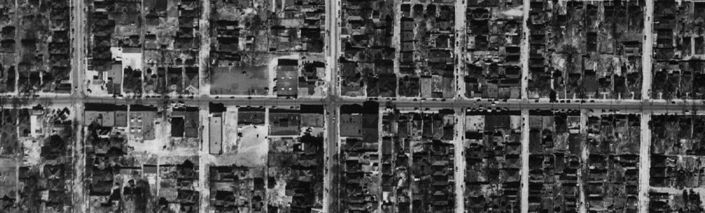 Black and white aerial photograph centered on Georgia Avenue showing cars and buildings including businesses and houses.