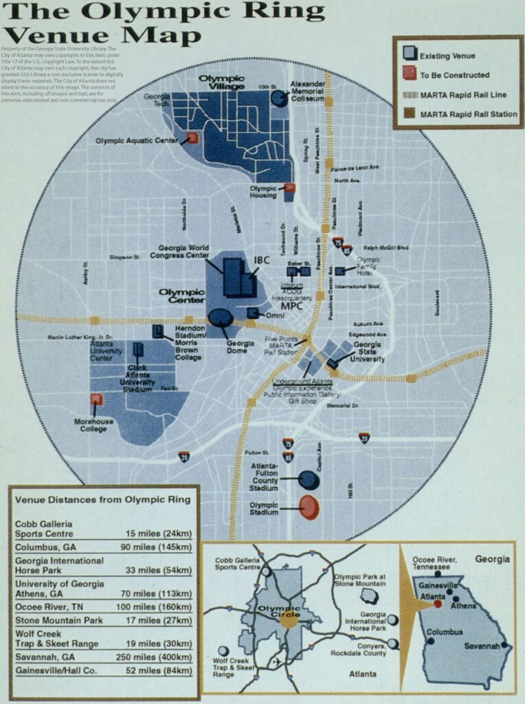 Map with circular view of Atlanta featuring Olympic venues including the Olympic Village northwest of I75, and the Olympic Center west of I75 and North of I20, just west of the intersection of the two main MARTA lines. The Atlanta Fulton County Stadium is indicated with a blue circle, and the Olympic Stadium is indicated with a red circle just south of it toward the bottom of the map.