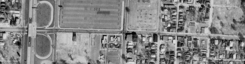 Black and white aerial image centered on Georgia Avenue with large open parking areas in the northwestern and western part beside the highway cloverleaf.
