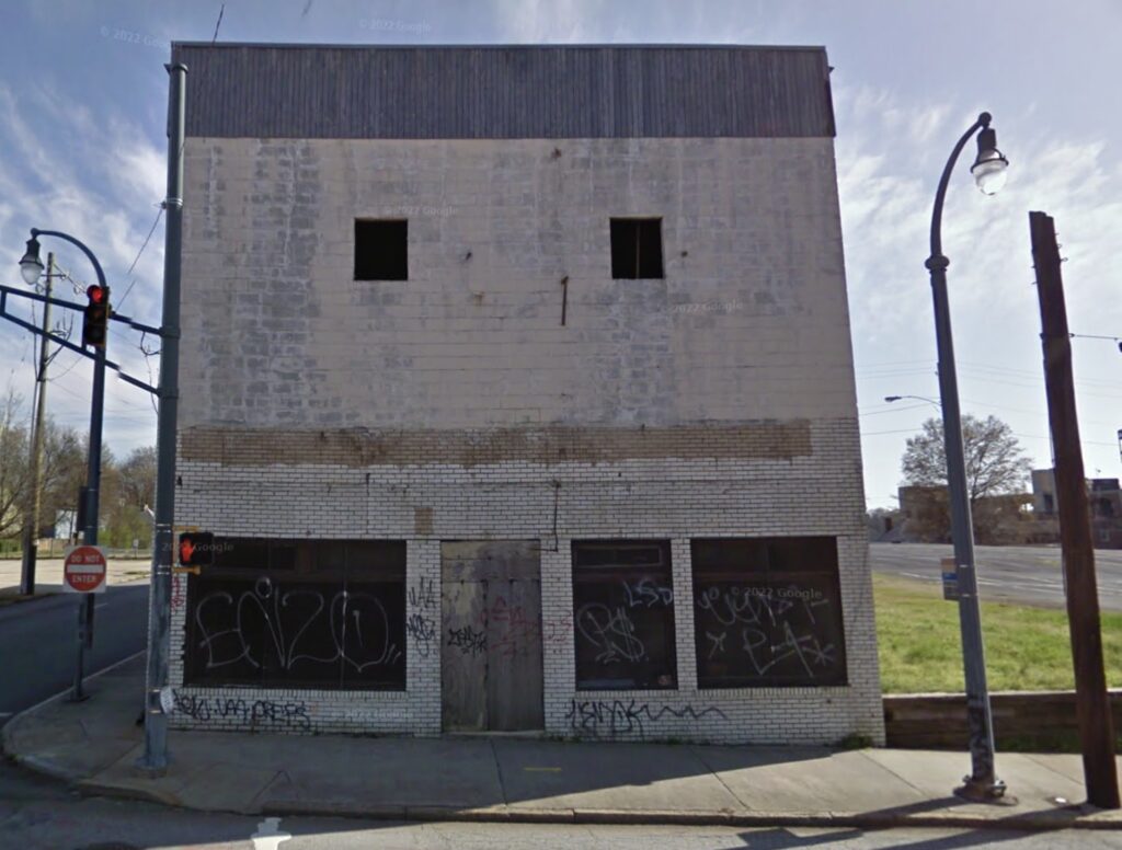 Color photogrpah of empty two story storefront with blank facade