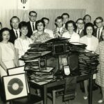Black and white image of a group of unidentified women and men at WSB radio station in the 1960s
