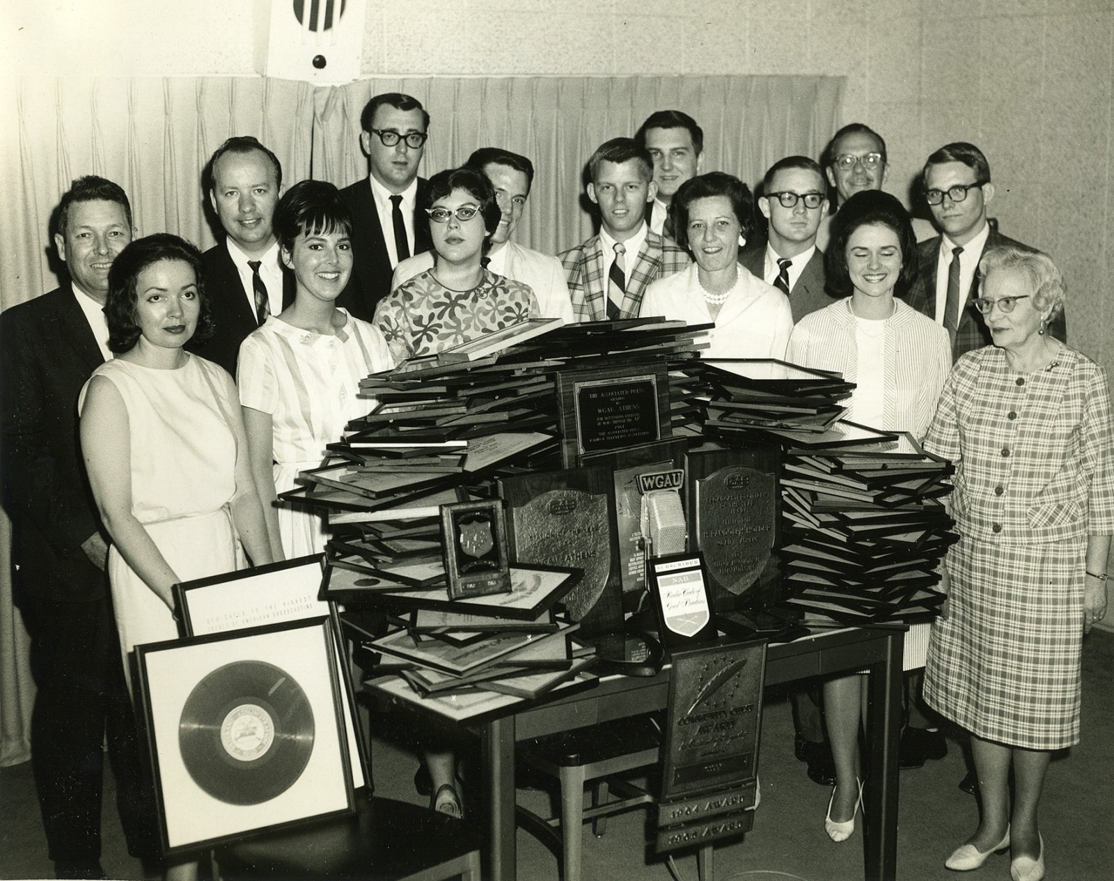 Black and white image of a group of unidentified women and men at WSB radio station in the 1960s