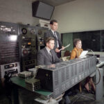 Image of two men and one woman in WSB control room