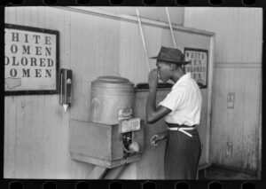 Negro drinking at "colored" water cooler in streetcar terminal, Oklahoma City, Oklahoma, July, 1939, photograph by Russell Lee Courtesy of Library of Congress, Farm Security Administration Collection, LC-USF33-002966-M3 DLC.