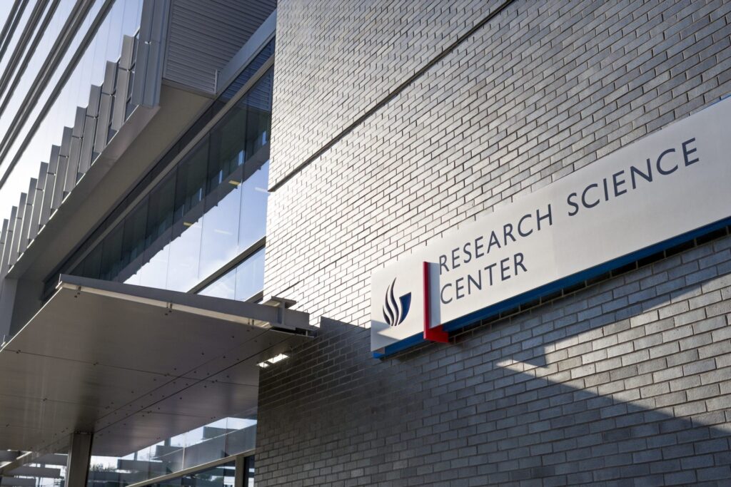 Color photo of a building with a brick facade and a sign with the GSU logo that reads Research Science Center