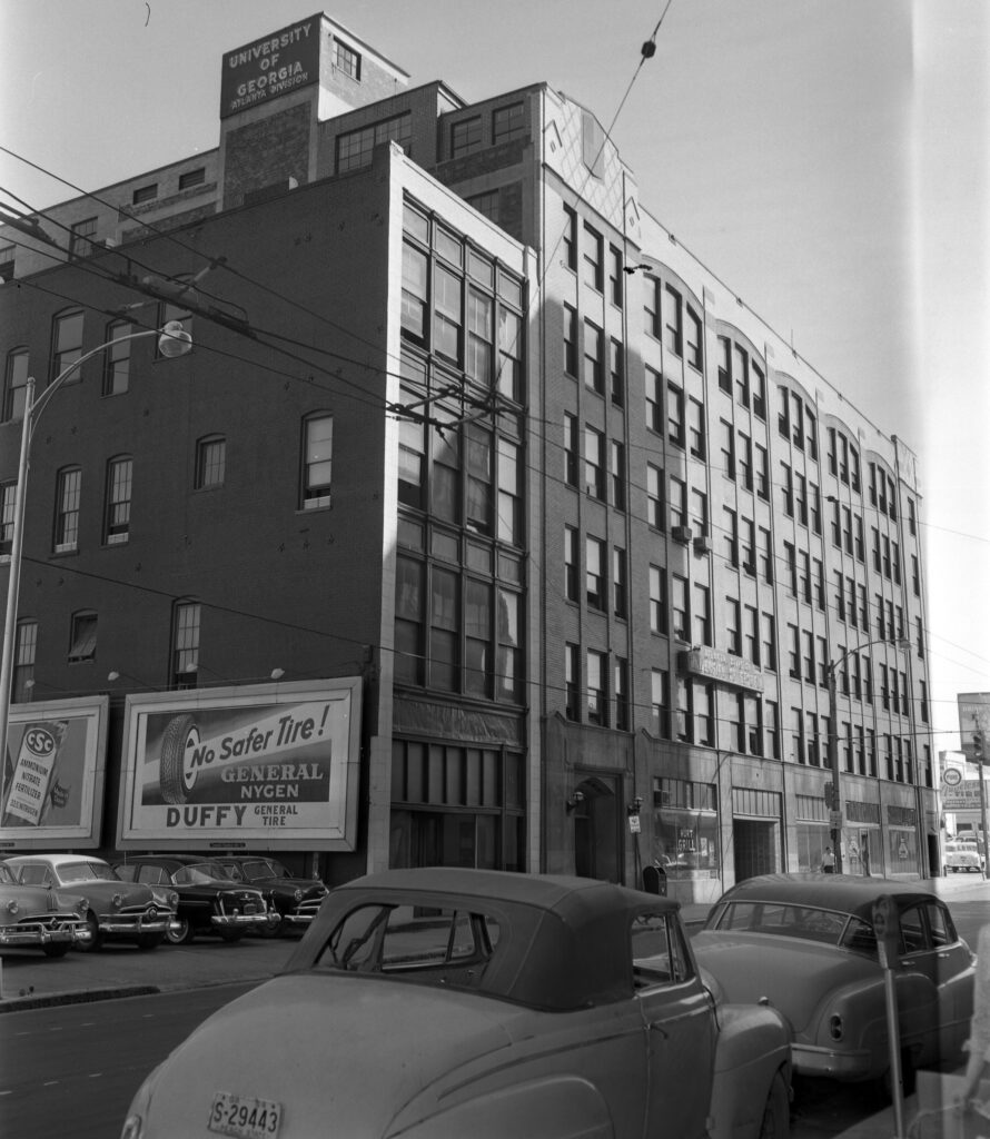 Kell Hall pictured from the street with cars parked in front and to the side of the building, early 1950s